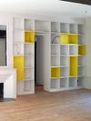 yellow and white floor to ceiling bookshelf