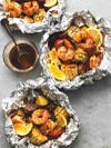 seafood bakes in aluminum with corn