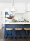 navy blue kitchen island with bar stools near by