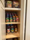 pantry shelves with cans stacked