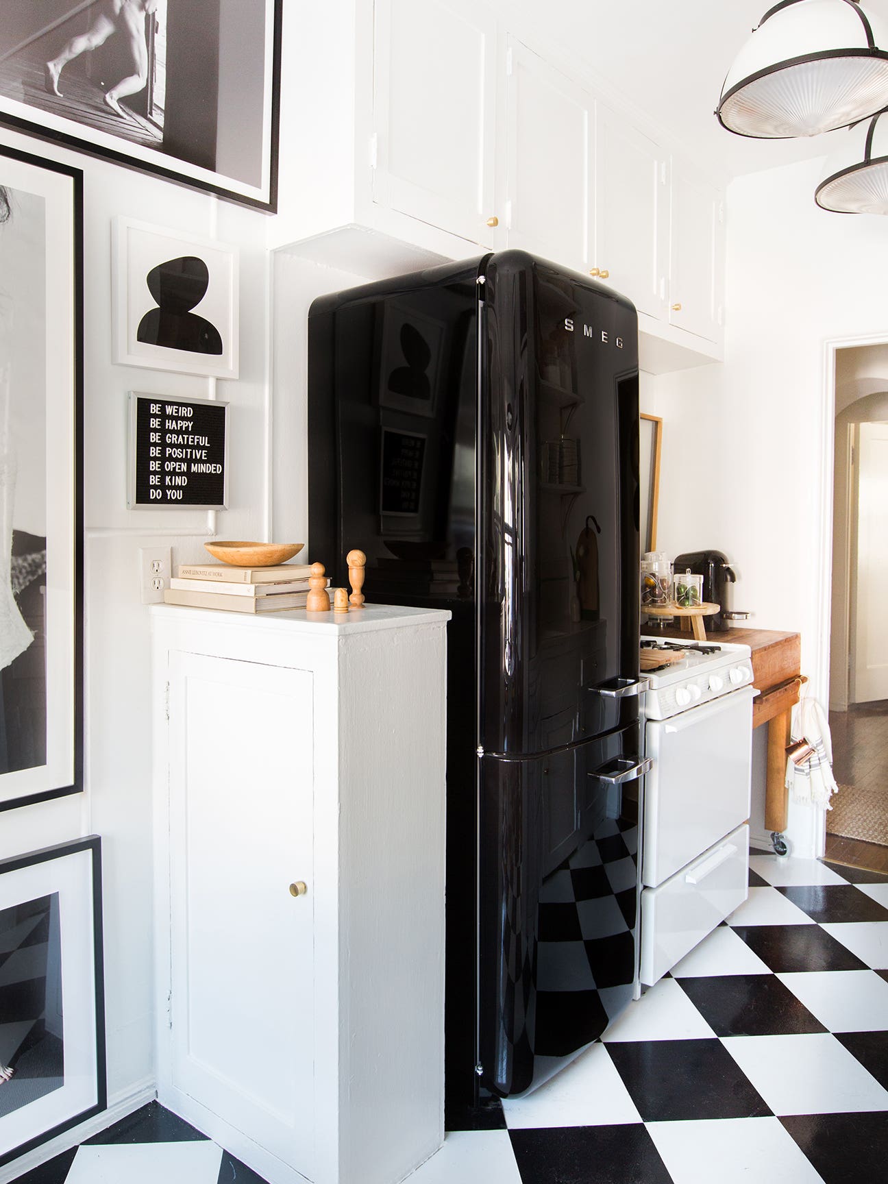 black and white kitchen with blacks fridge