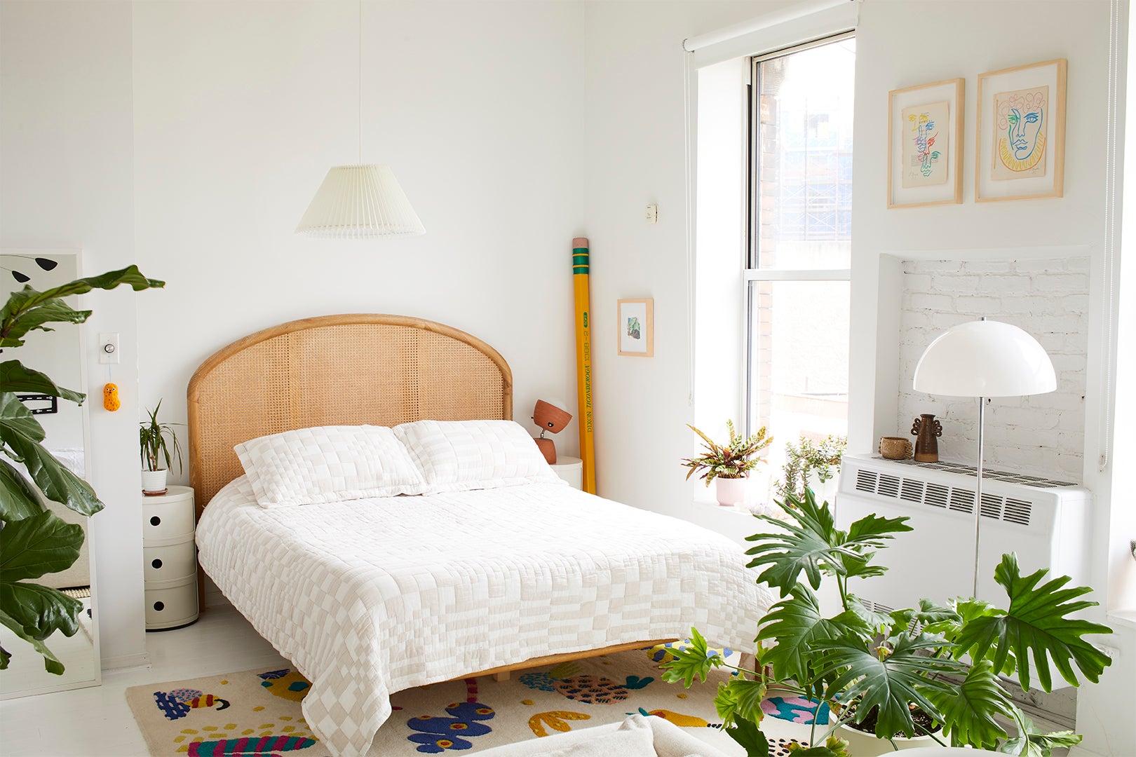 White bedroom with quirky accessories and plants