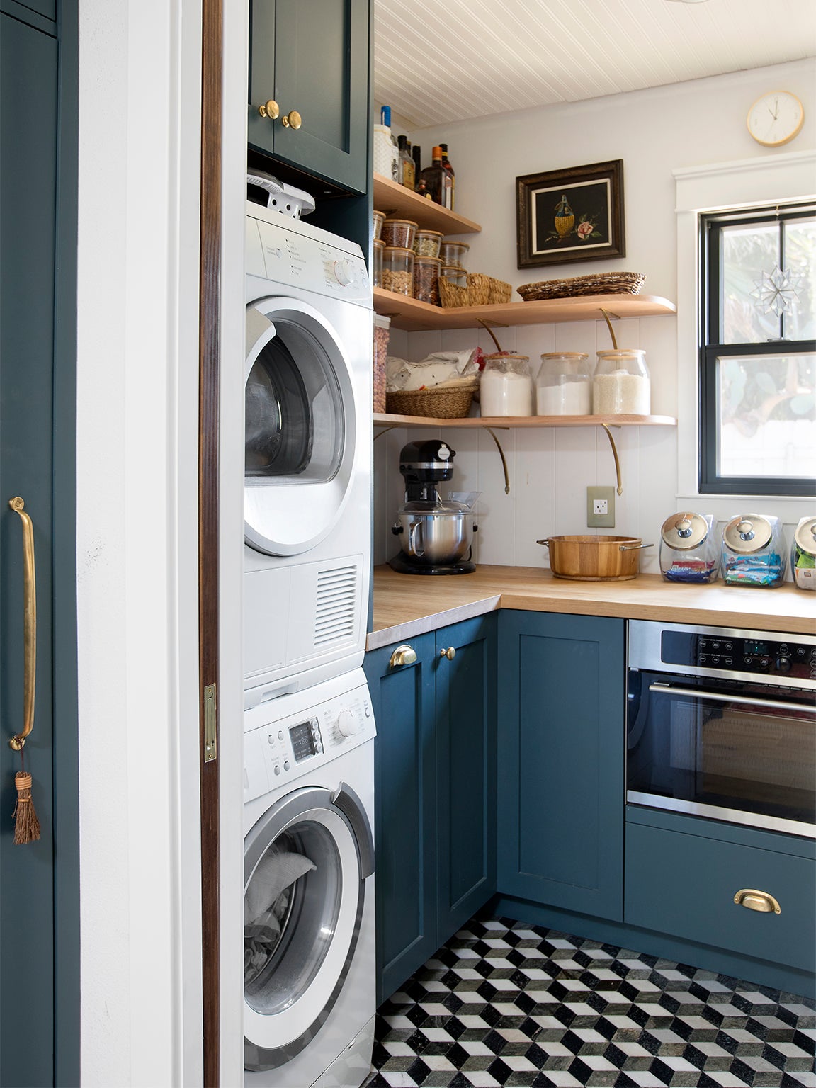 blue pantry with stacked laundry machines