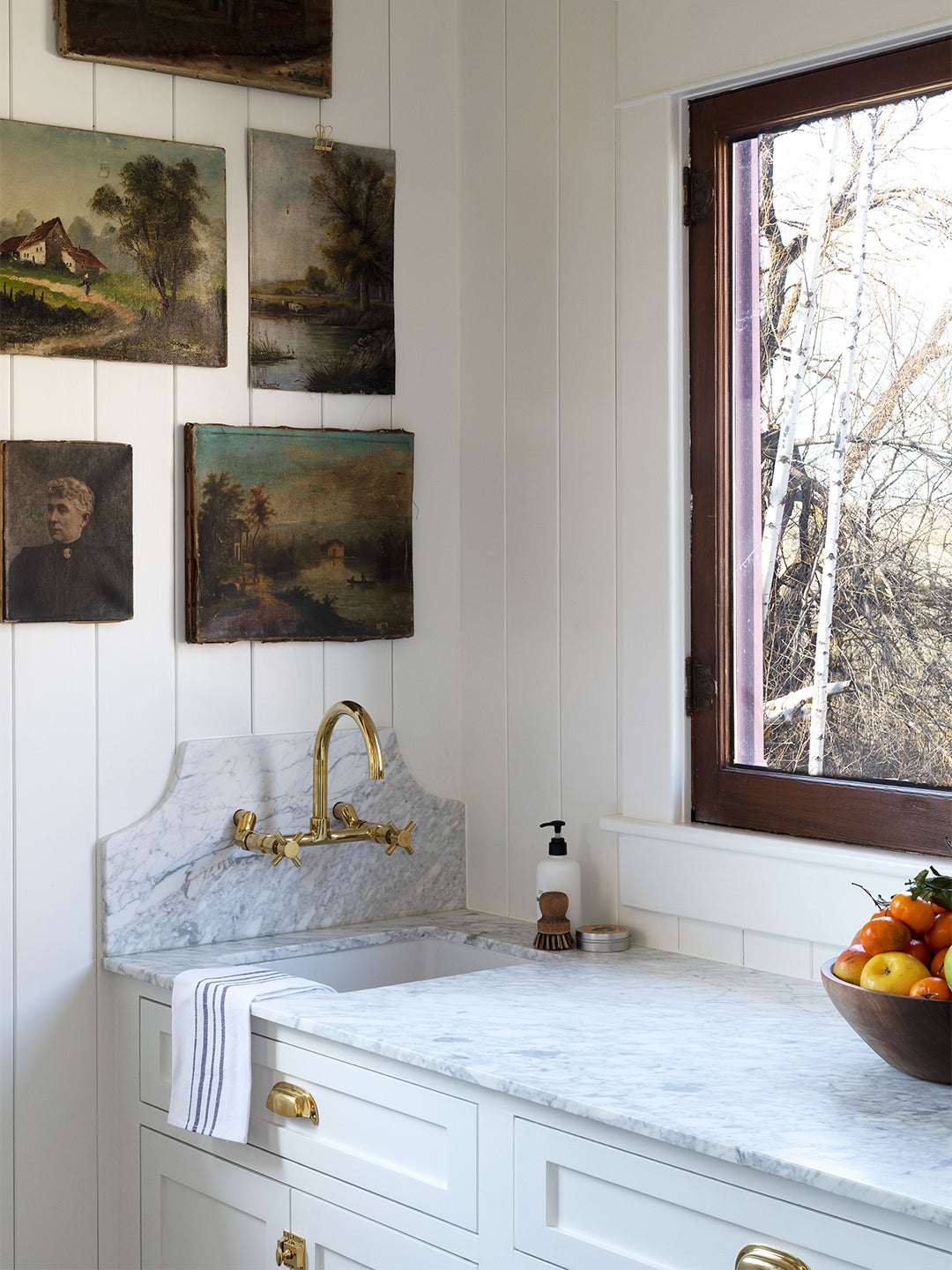 marble countertop with oil paintings on the wall