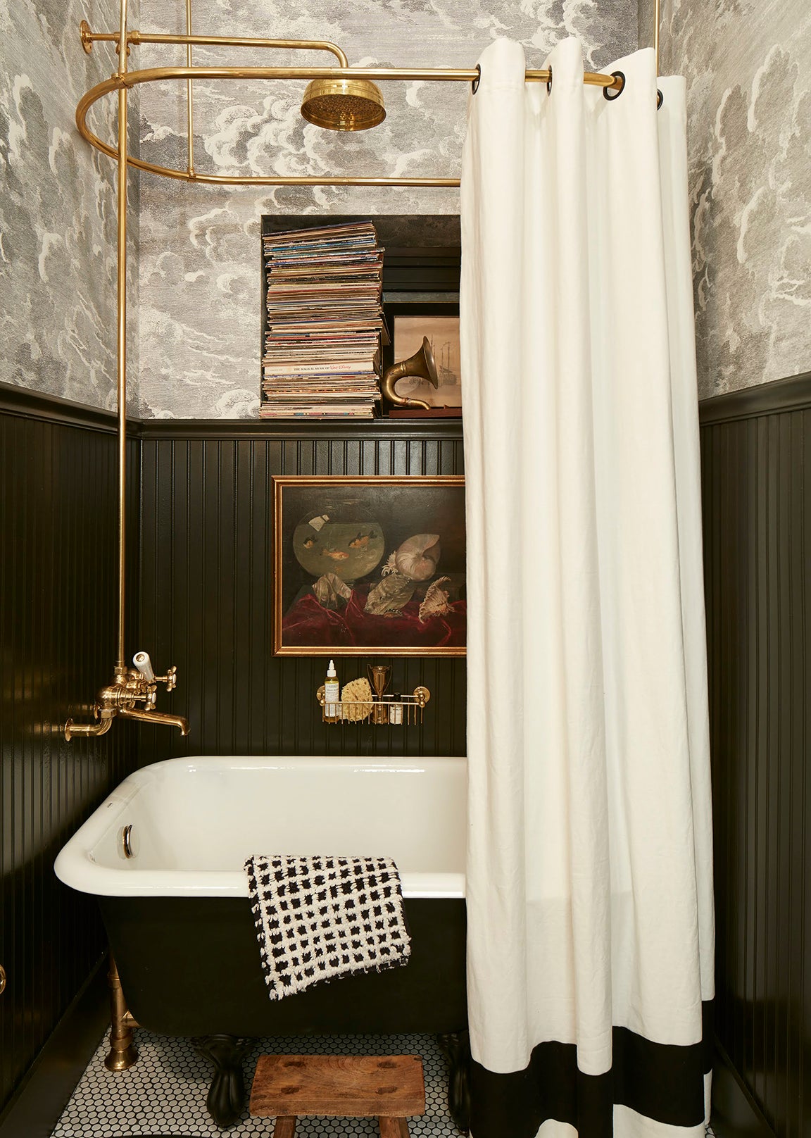 Bathroom with dark wainscoting and hanging painting