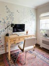 wood desk and floral wallpaper