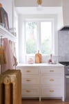 white kitchen cabinets with antique gold radiator