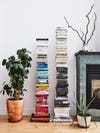 stack of color coded books next to plant