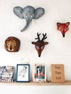 menagerie heads on a wall with books