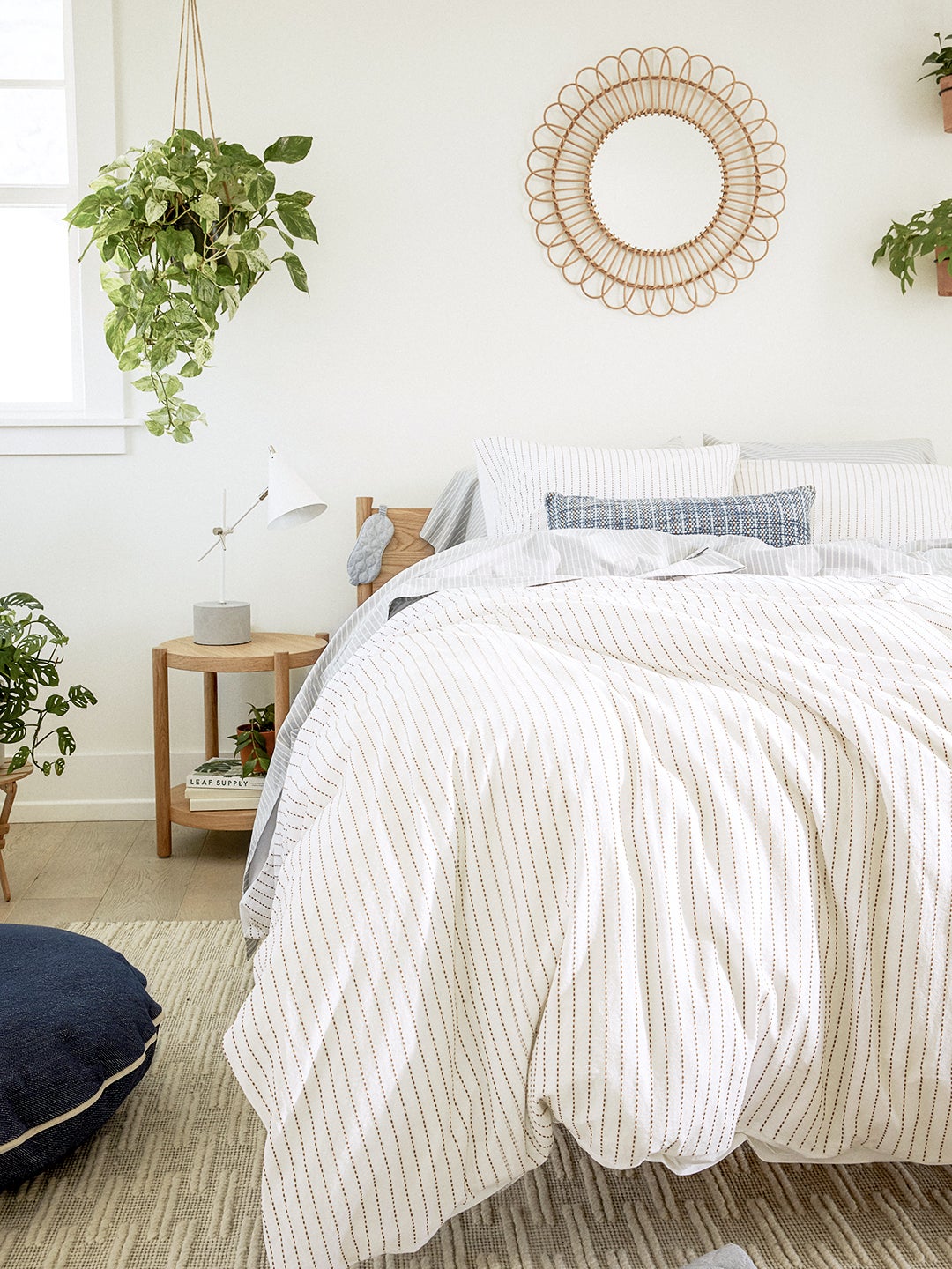white bed with hanging plant