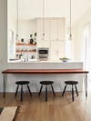 cream colored kitchen with stools at bar