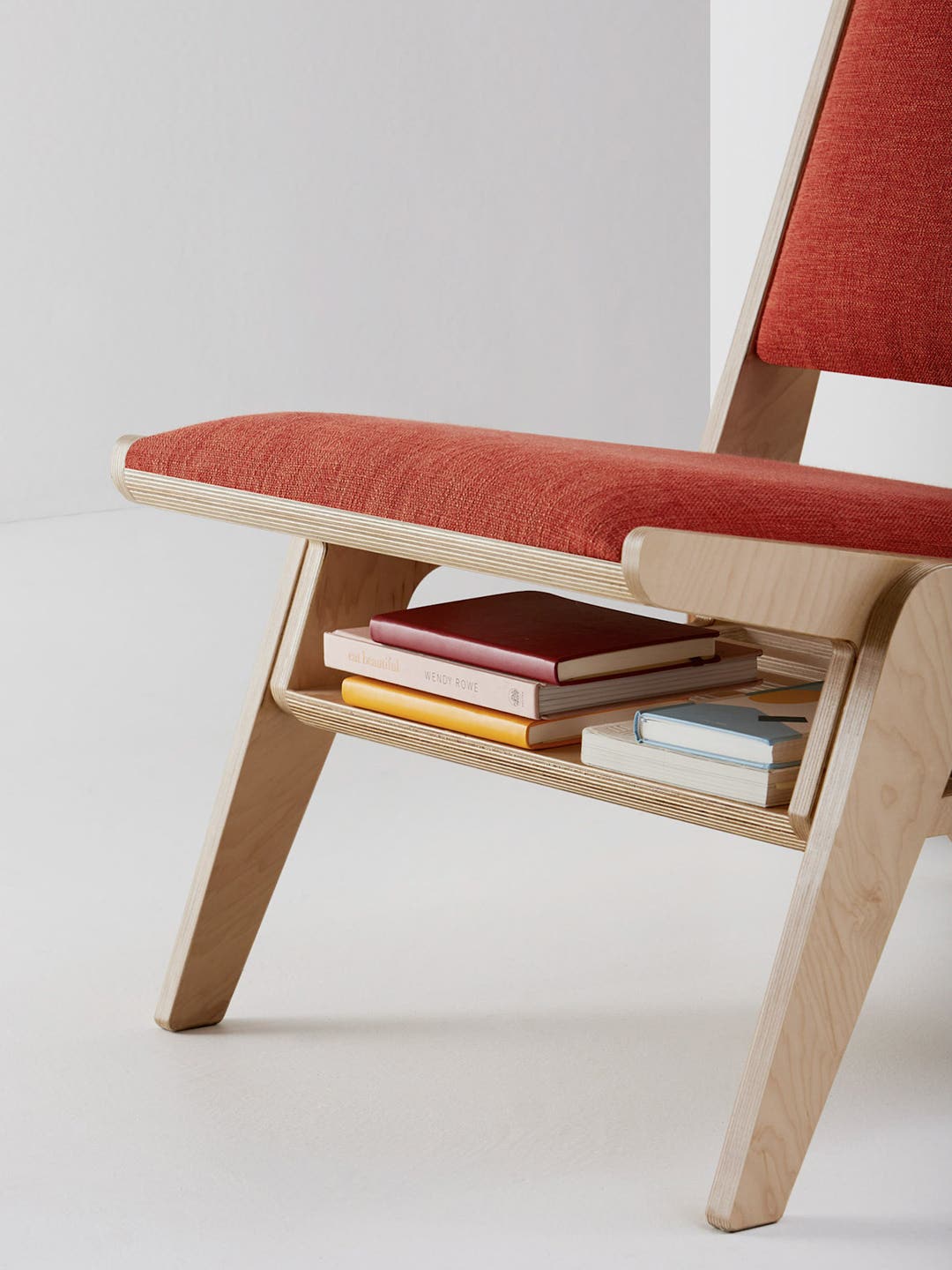 red chair with shelf for books