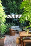 outdoor sitting area with striped canopy covering it