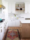 white kitchen with red vintage runner