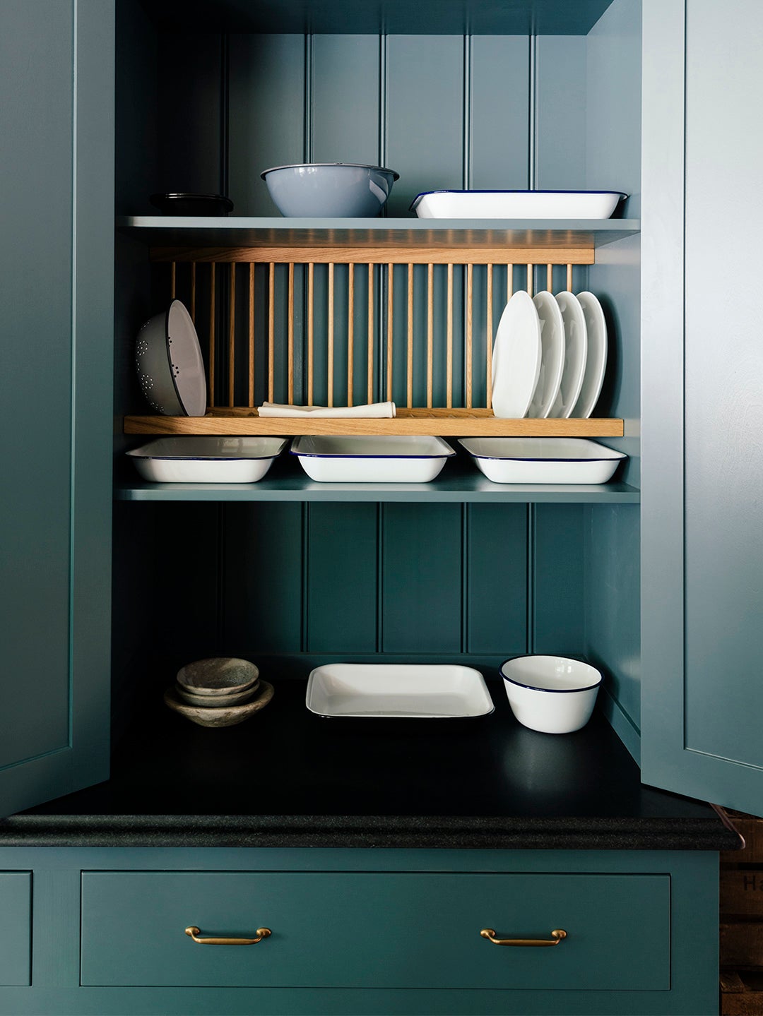 blue kitchen cabinet with wooden plate rack