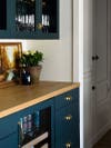 blue glass cabinets and wood counters
