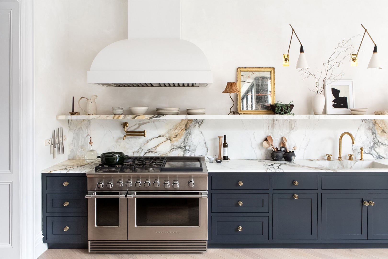 blue lower cabinets with dramatic white marble backsplash