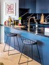 wire barstools at a blue and black countertop