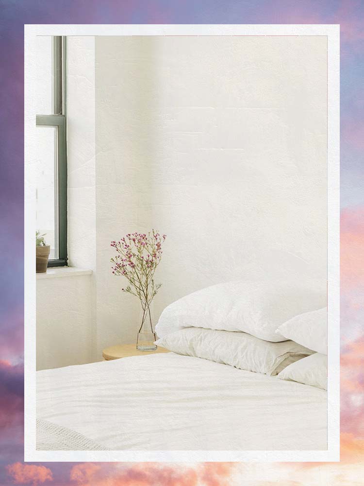 White Bed With Stacked Pillows