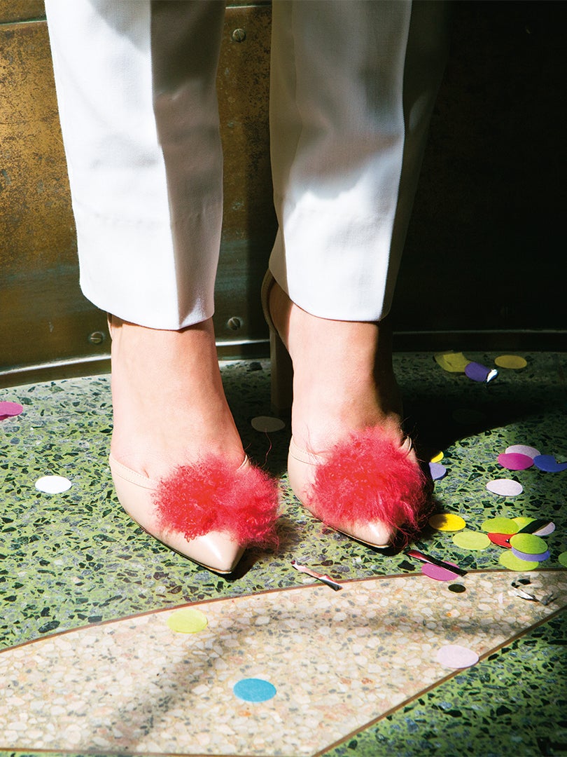 shoes with pom poms and confetti on the floor