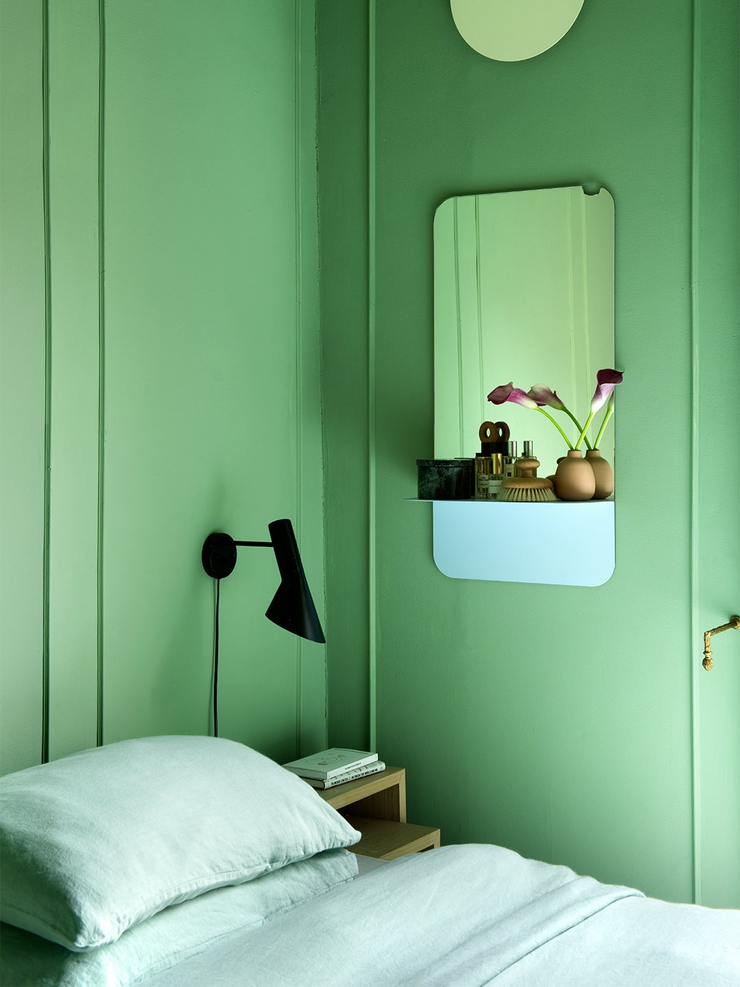 Small bedroom with green walls