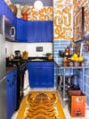 cobalt blue kitchen cabinets with orange wall mural