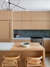 natural wood kitchen cabinets and green backsplash
