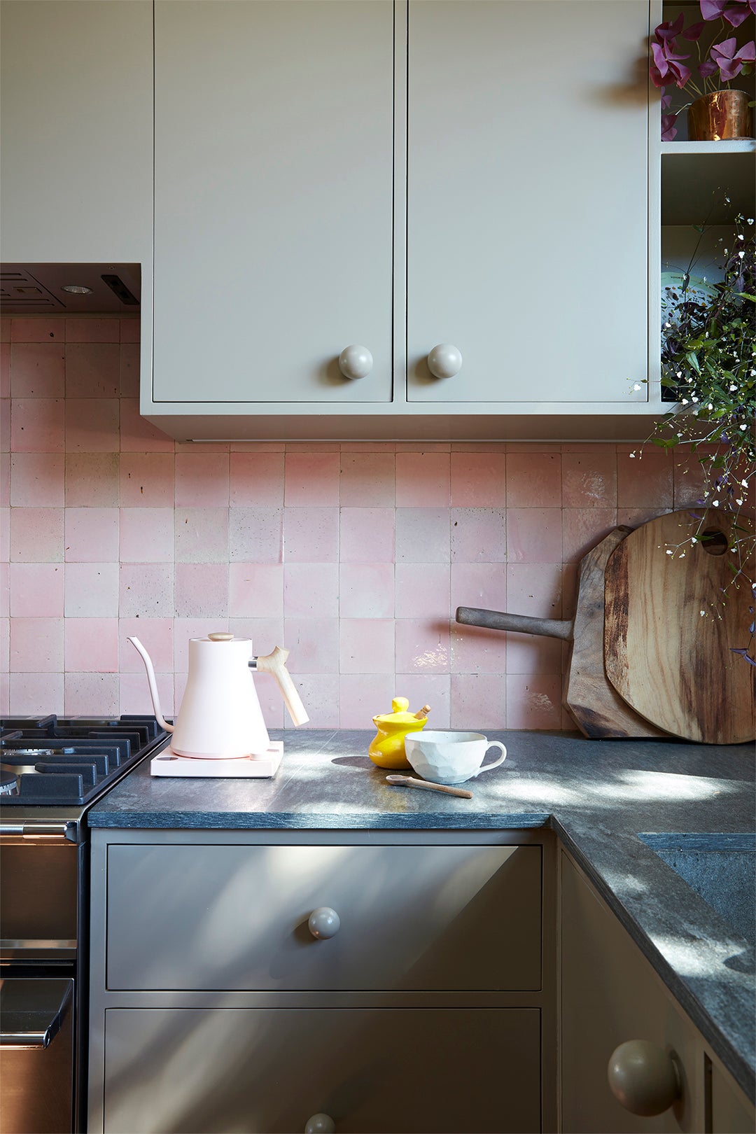 pink square backsplash and gray cupboards
