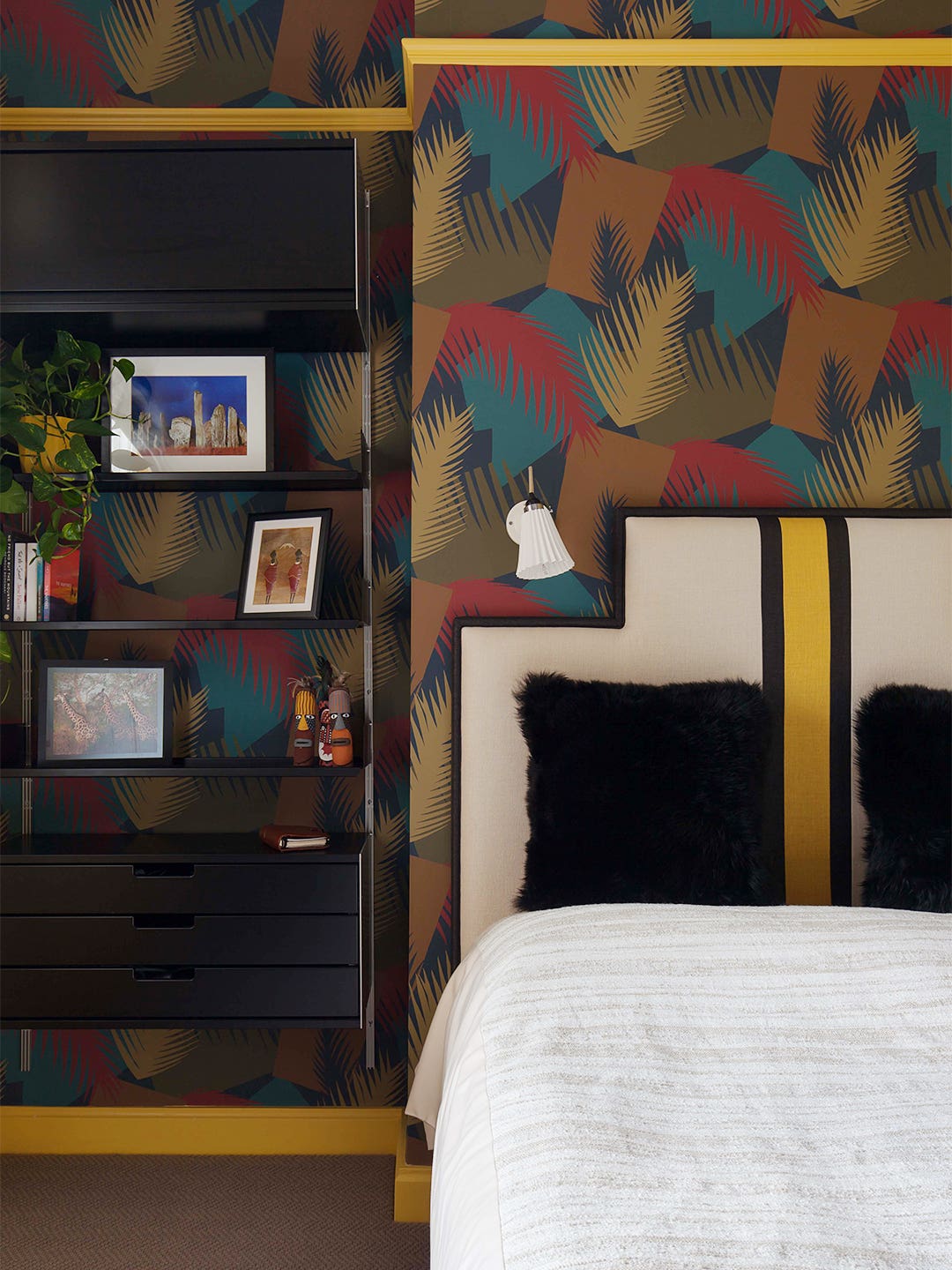multicolored accent wall in yellow guest room