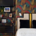 multicolored accent wall in yellow guest room
