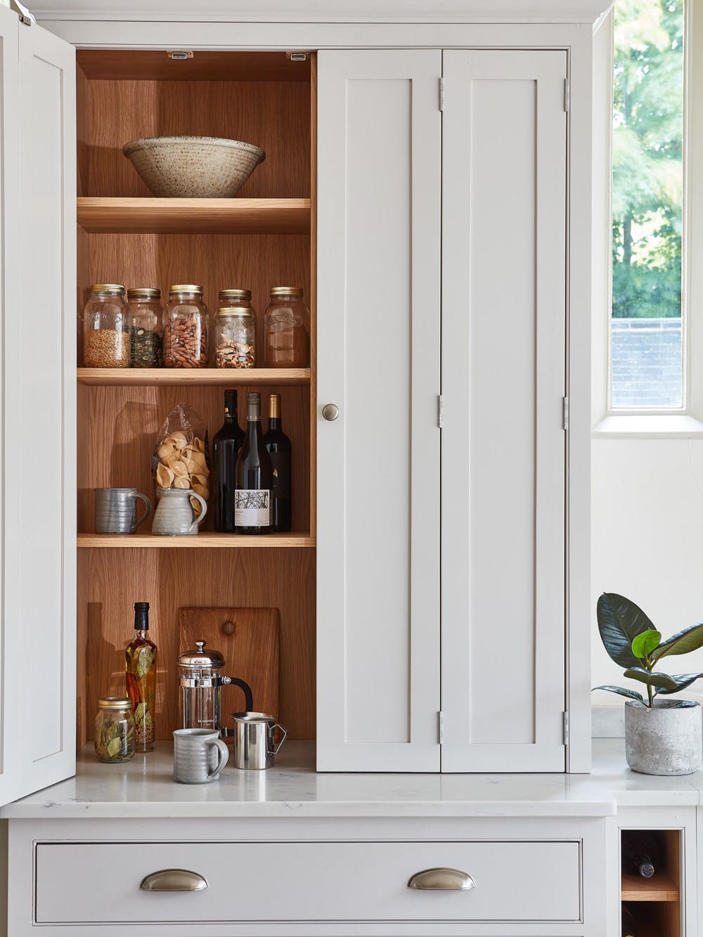 grey kitchen cabinet with organized pantry staples
