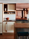 cooper backsplahs in a white and wood kitchen