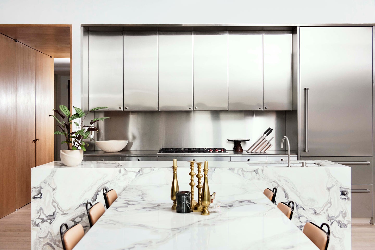 Kitchen with stainless steel cabinets and marble island