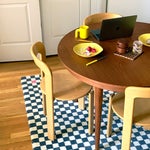 dining room table and chairs with grid rug