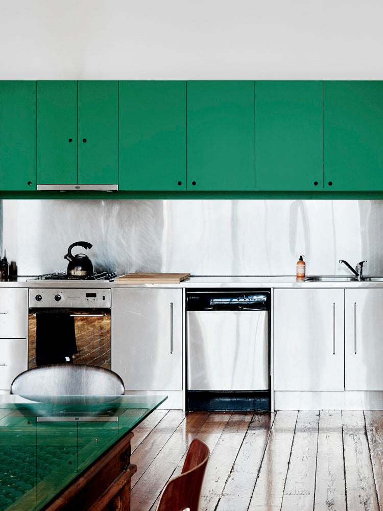 Stainless steel kitchen with green cabinets