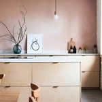 pink kitchen with natural wood cabinets