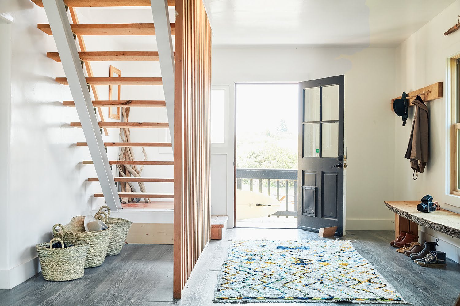 entry with stairs and multicolored rug