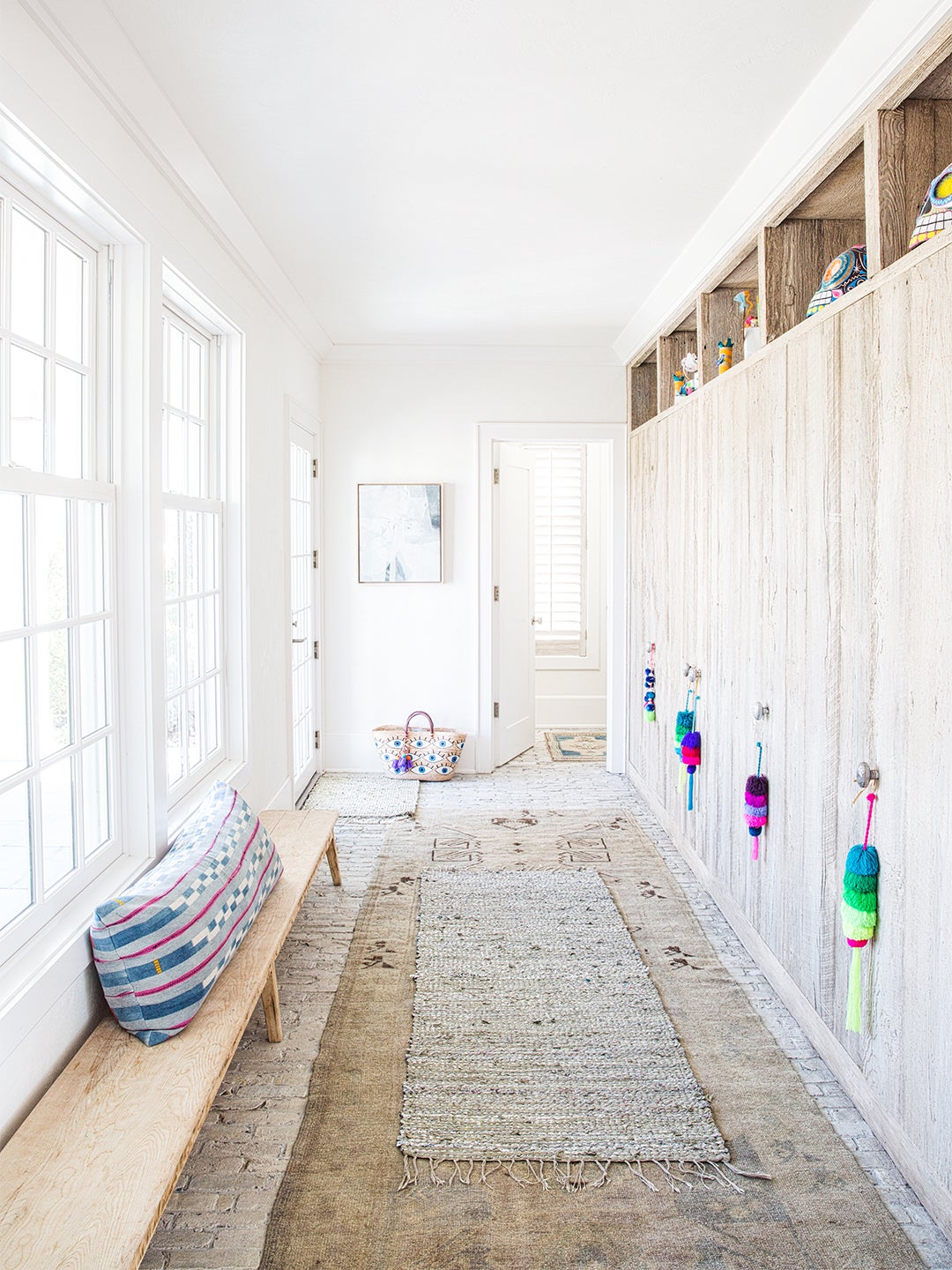 light-filled entry with two rugs layered