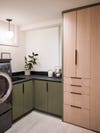 Renovated laundry room with cabinets