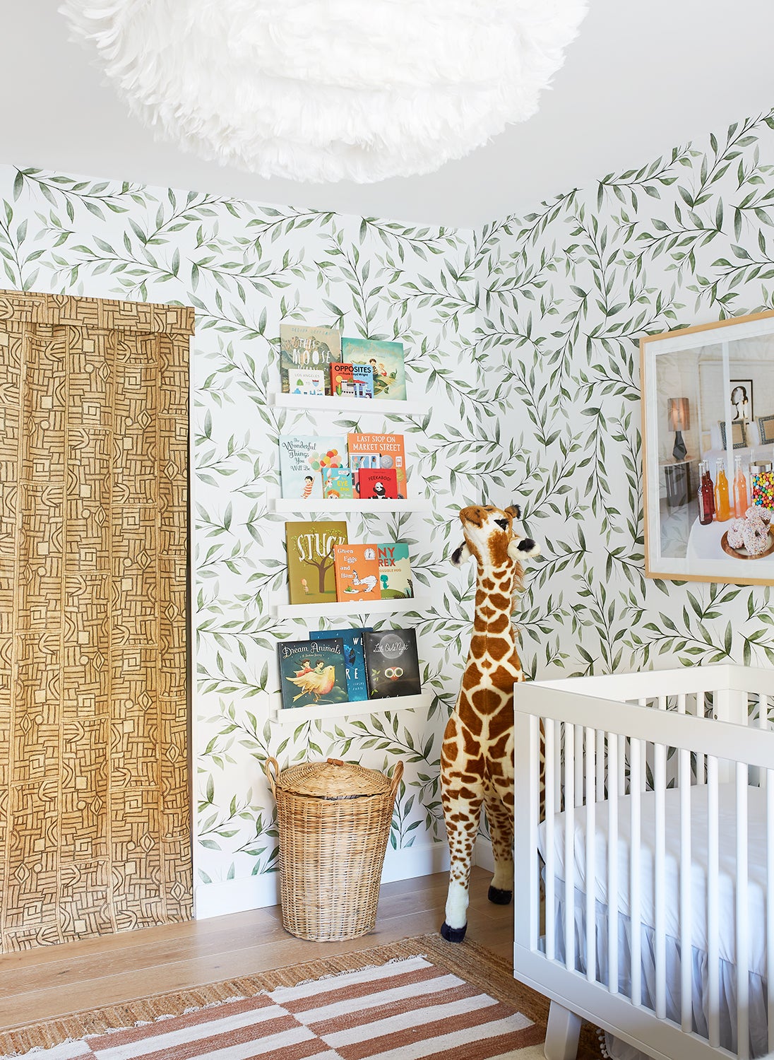 Nursery with leafy wallpaper