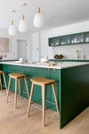 modern green kitchen with bar stools