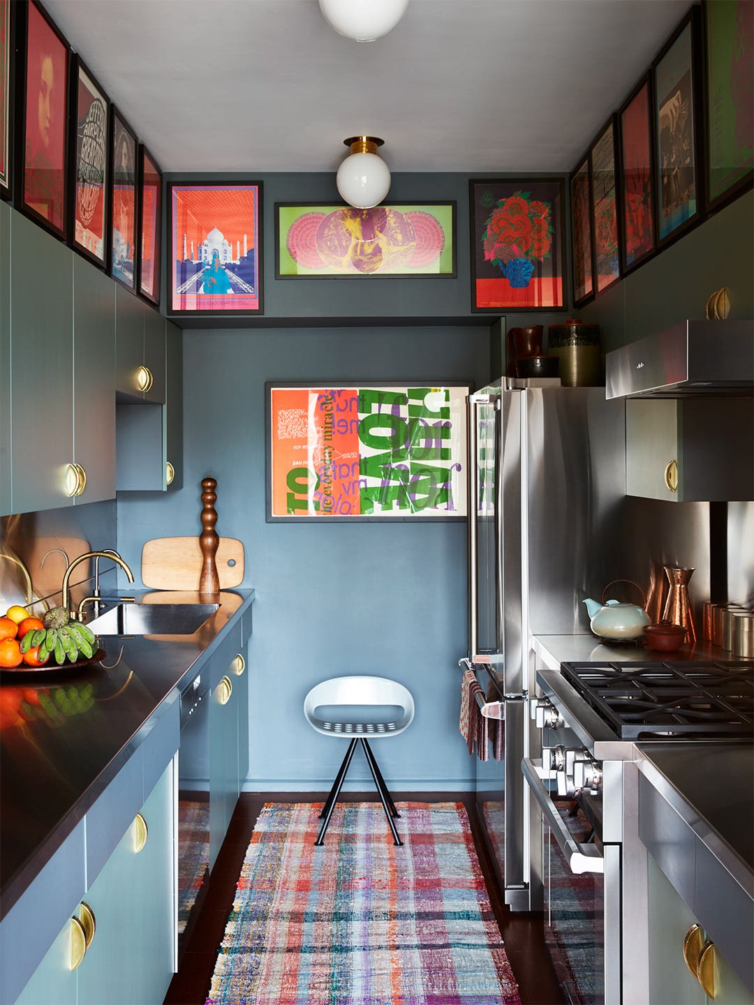 blue kitchen with artwork on walls