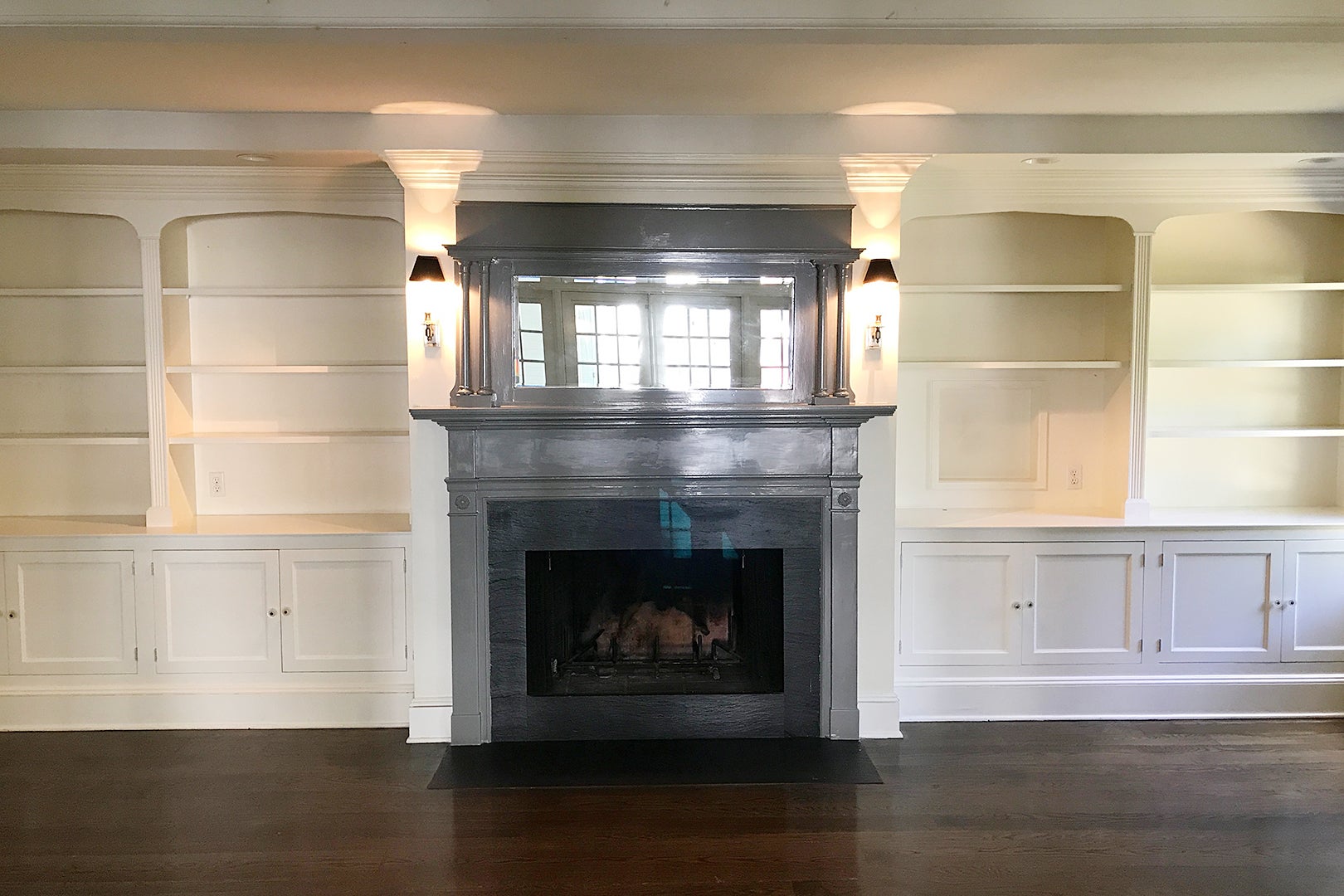 gray fireplace and built in shelves