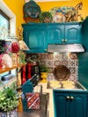 teal kitchen cabinets and colorful backdrop