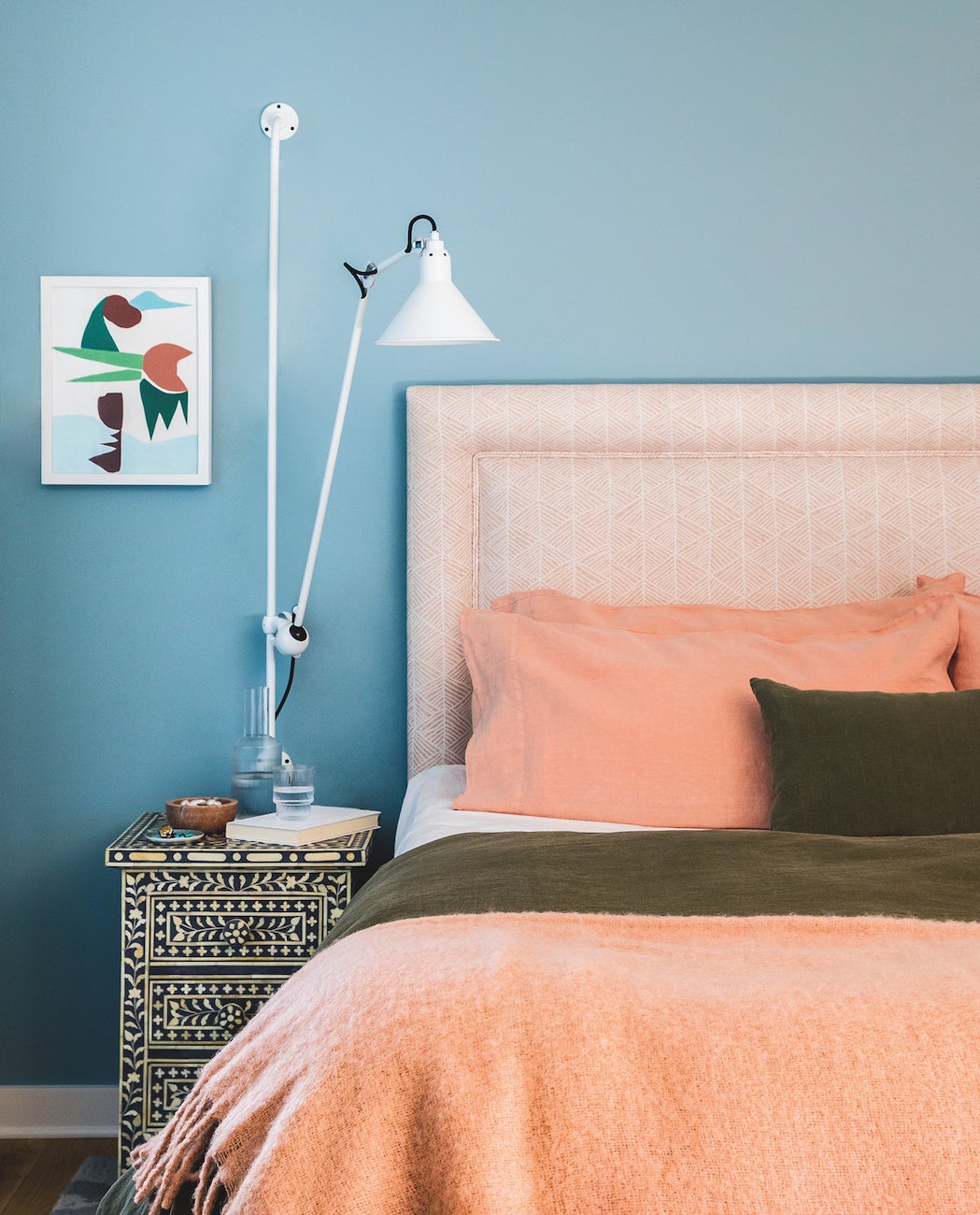 Bedroom with blue walls and peach sheets
