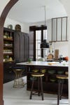 dark wood kitchen with lots of ceramic plates