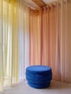 rainbow colored curtains and Klein blue stool