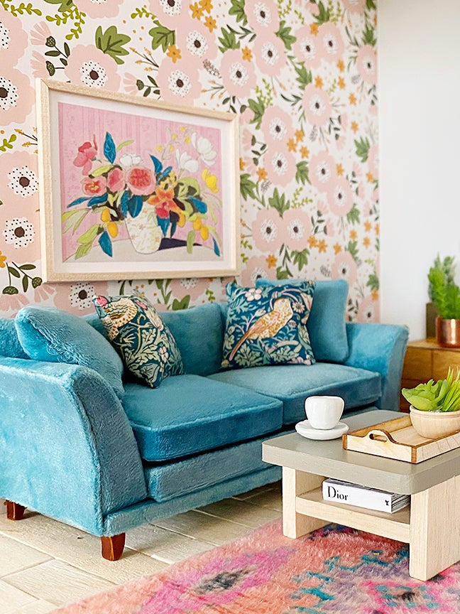 blue sofa with pink floral wallpaper