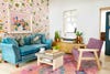 blue sofa with pink floral wallpaper
