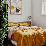 Bedroom with low bed and yellow sheets